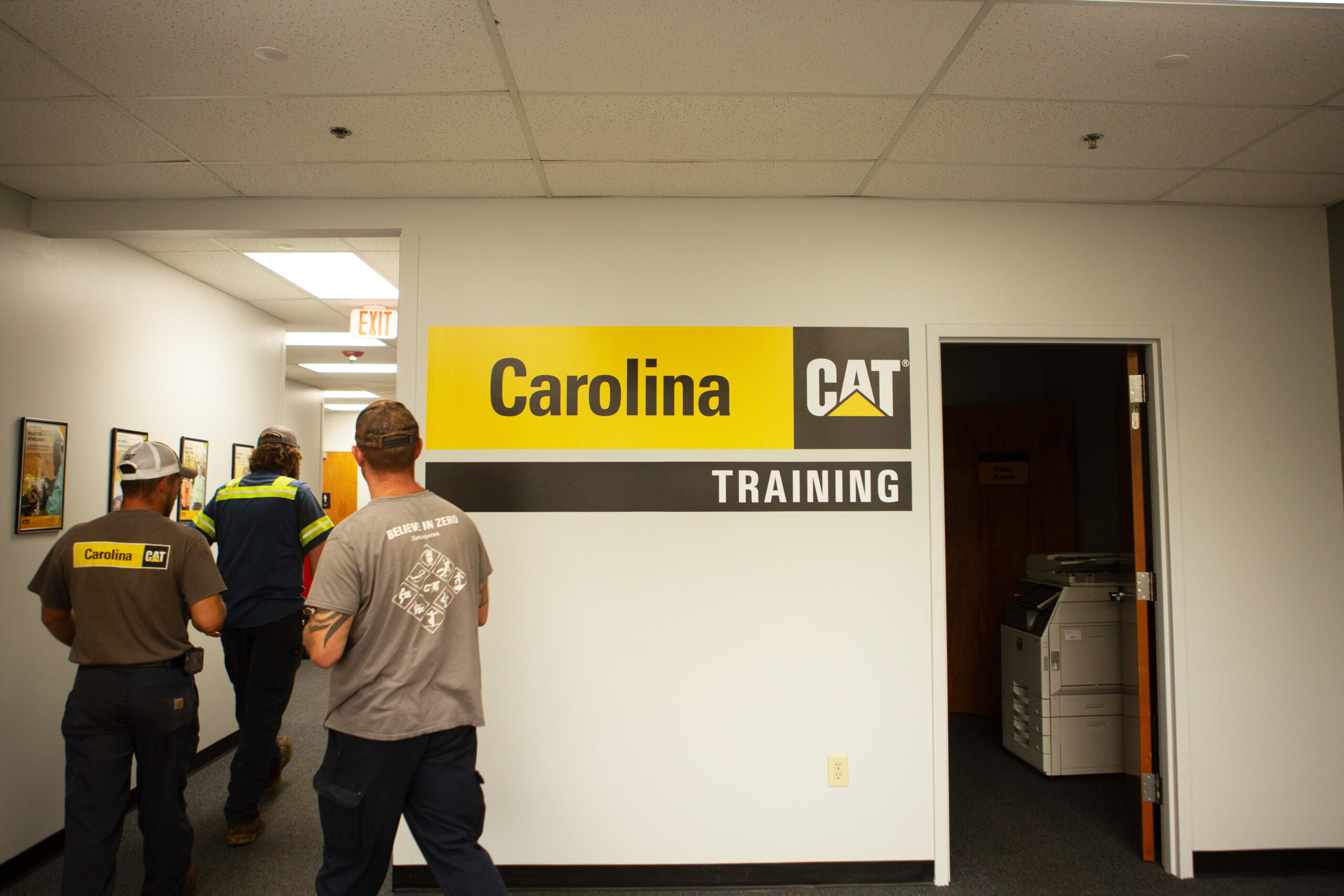 technicians walking down the hallway of the Carolina Cat Training facility