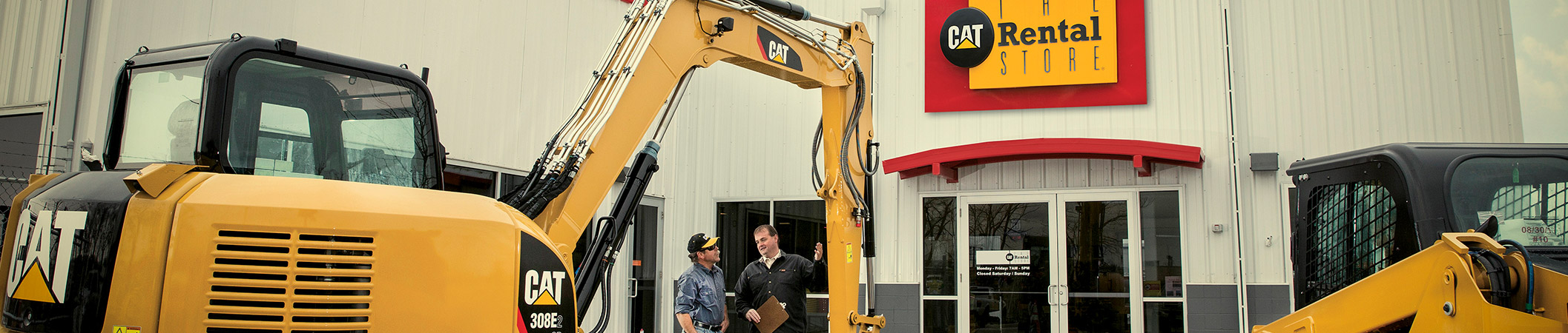 Two men looking at CAT Rentals